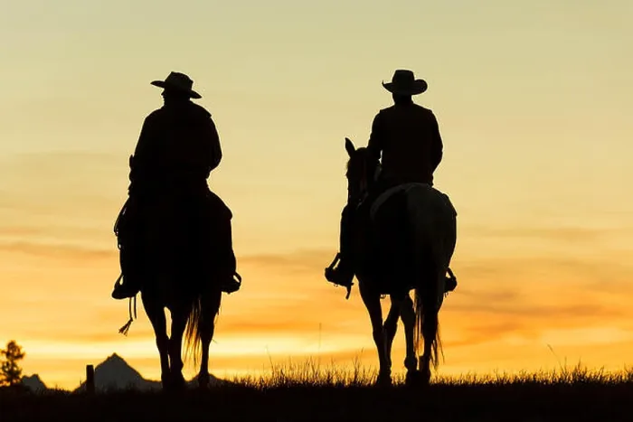 Framed Print : Two cowboys riding on horseback in a Prairie landscape at sunset Framed Print : Two cowboys riding on horseback in a Prairie landscape at sunset