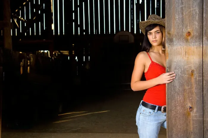 Framed Print : Cowgirl in barn doorway with hat and tank top Framed Print : Cowgirl in barn doorway with hat and tank top