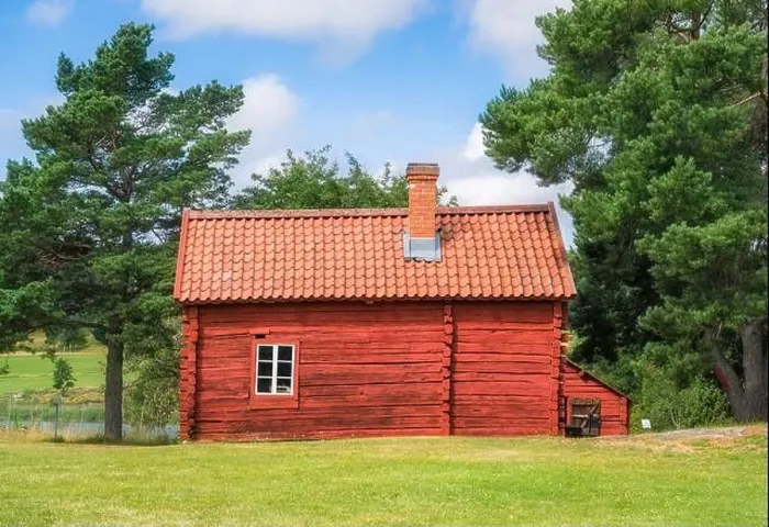 Framed Print : Cozy red timber cottage with bright and sunny summer day in Åland, Finland Framed Print : Cozy red timber cottage with bright and sunny summer day in Åland, Finland