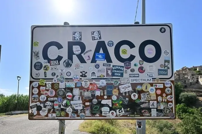 Framed Print : Craco, Italy - Aug 6, 2023: Sign at the entrance of the abandoned village of Craco, Basilicata region, Italy Framed Print : Craco, Italy - Aug 6, 2023: Sign at the entrance of the abandoned village of Craco, Basilicata region, Italy
