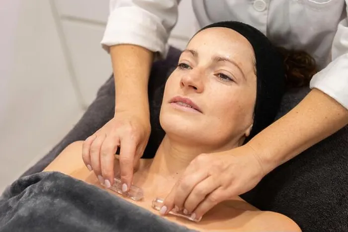 Framed Print : Crop masseuse doing massage to client in salon