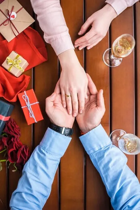 Framed Print : cropped image of boyfriend holding girlfriends hand with wedding ring Framed Print : cropped image of boyfriend holding girlfriends hand with wedding ring