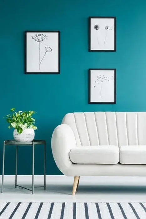 Framed Print : Cropped photo of a white sofa in living room interior with metal table with a plant and paintings on the green wall Framed Print : Cropped photo of a white sofa in living room interior with metal table with a plant and paintings on the green wall