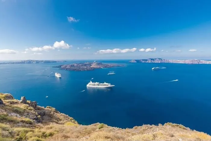 Framed Print : Cruise ship near Santorini, summer travel tourism boats in blue sea bay, cliffs of Santorini volcano island. Famous travel destination Framed Print : Cruise ship near Santorini, summer travel tourism boats in blue sea bay, cliffs of Santorini volcano island. Famous travel destination