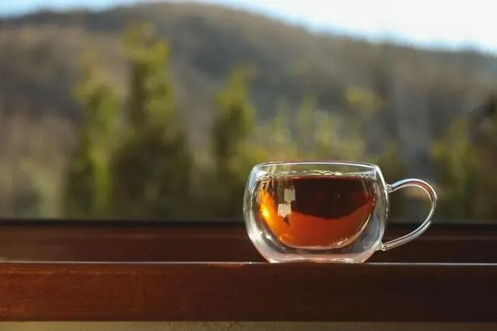 Framed Print : Cup of tea stands on wooden windowsill Framed Print : Cup of tea stands on wooden windowsill