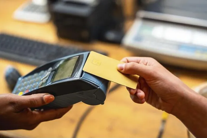 Framed Print : Customer making a purchase using a credit card on a point of sale terminal Framed Print : Customer making a purchase using a credit card on a point of sale terminal