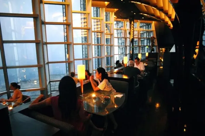 Framed Print : Customers are pictured at Cloud 9 Bar in the Grand Hyatt Shanghai in Jinmao Tower in the Lujiazui Financial District in Framed Print : Customers are pictured at Cloud 9 Bar in the Grand Hyatt Shanghai in Jinmao Tower in the Lujiazui Financial District in