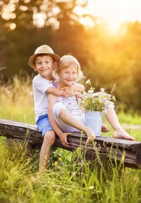 Framed Print : Cute boy and girl in love. They sitting on bench at sunset Framed Print : Cute boy and girl in love. They sitting on bench at sunset