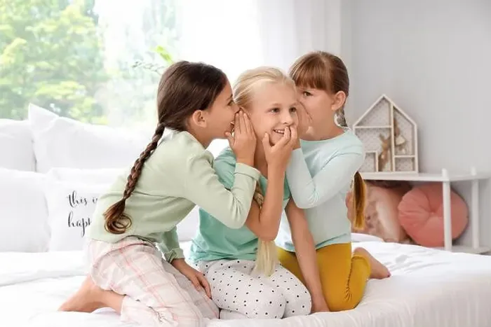 Framed Print : Cute little girls telling secrets in bedroom Framed Print : Cute little girls telling secrets in bedroom