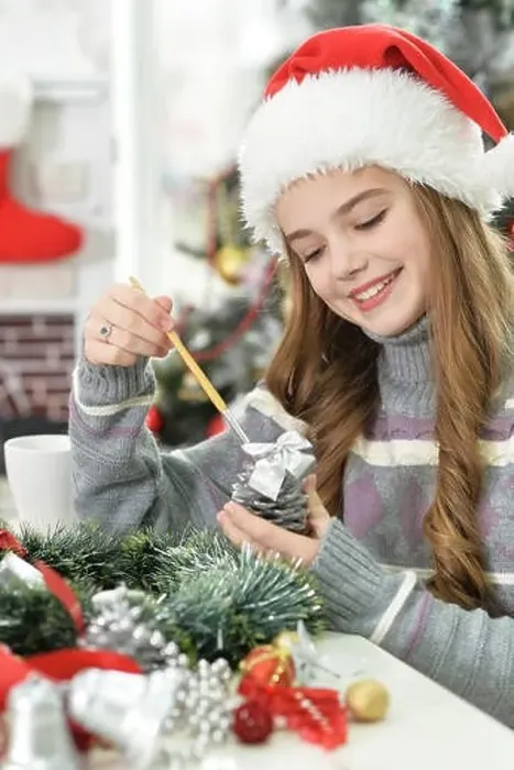Framed Print : Cute long-haired girl preparing for Christmas at home Framed Print : Cute long-haired girl preparing for Christmas at home