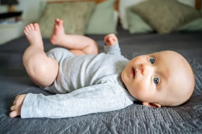 Framed Print : Cute toddler boy lying on bed at home Framed Print : Cute toddler boy lying on bed at home