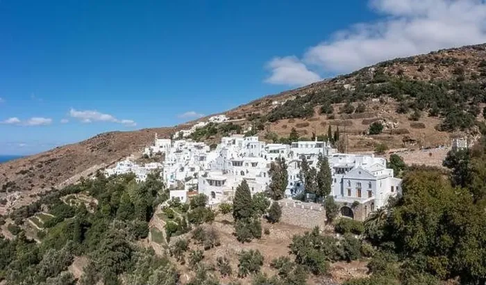 Framed Print : Cyclades, Greece. Tinos Greek island, aerial drone view of Kardiani village town, white color buildings, cloudy blue sky Framed Print : Cyclades, Greece. Tinos Greek island, aerial drone view of Kardiani village town, white color buildings, cloudy blue sky