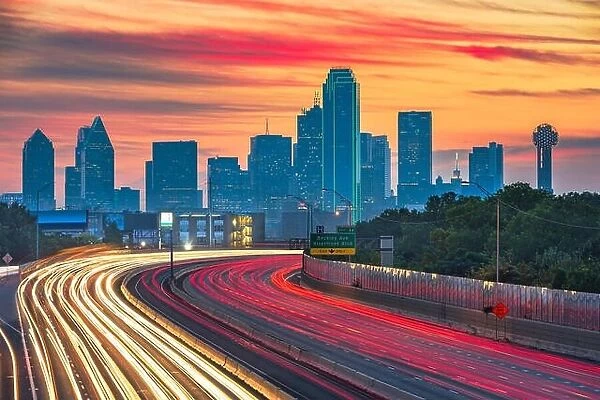Dallas, Texas, USA downtown skyline and highway at dawn