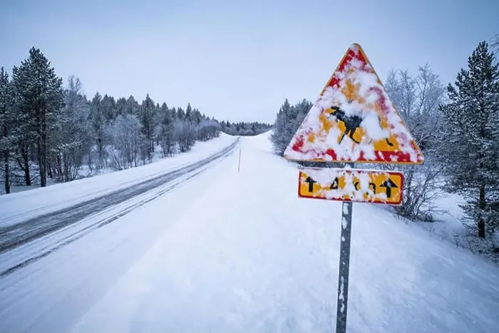 Framed Print : Danger roadsign covered in snow on an empty, snowy road in Lapland Framed Print : Danger roadsign covered in snow on an empty, snowy road in Lapland