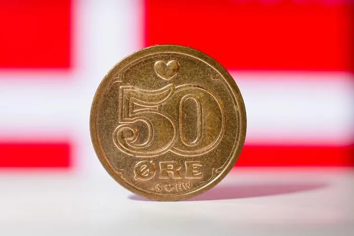 Framed Print : Danish 50 ore with a Danish flag behind in a background - macro shallow focus Framed Print : Danish 50 ore with a Danish flag behind in a background - macro shallow focus
