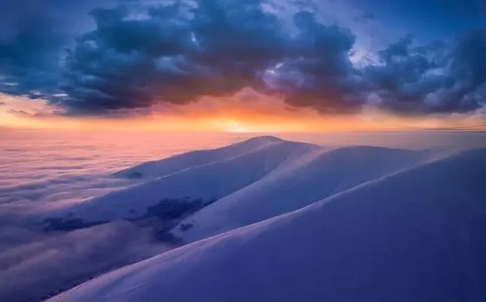 Framed Print : Dawn over the tops of snow-capped mountains view from a drone Framed Print : Dawn over the tops of snow-capped mountains view from a drone