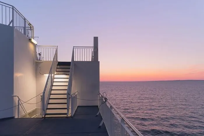 Framed Print : Deck of a cruise ship during sunset. Calm ocean and clear pink sky in evening time. Cruise vacations background. Minimalism in photography Framed Print : Deck of a cruise ship during sunset. Calm ocean and clear pink sky in evening time. Cruise vacations background. Minimalism in photography