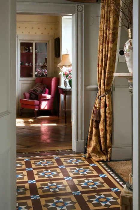 Framed Print : Decorative Victorian floor tiles in an entrance hall with drawing room glimpsed beyond Framed Print : Decorative Victorian floor tiles in an entrance hall with drawing room glimpsed beyond