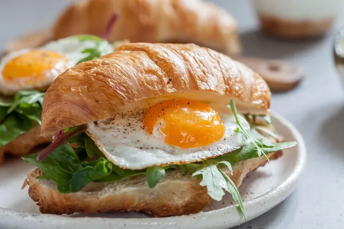 Framed Print : Delicious Breakfast with Croissant sandwiches with Fried Egg, Salad Leaves and avocado Framed Print : Delicious Breakfast with Croissant sandwiches with Fried Egg, Salad Leaves and avocado
