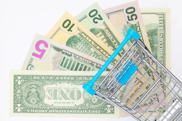 Framed Print : Different us dollar banknotes and empty shopping trolley. Flat lay photography Framed Print : Different us dollar banknotes and empty shopping trolley. Flat lay photography