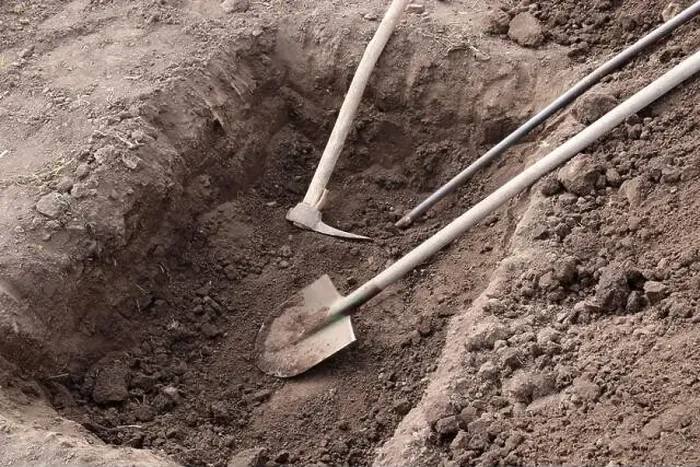 Framed Print : Digging a pit. Pit in the ground. The shovel, pickaxe and crowbar lay in the pit Framed Print : Digging a pit. Pit in the ground. The shovel, pickaxe and crowbar lay in the pit