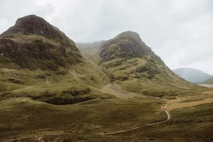 Framed Print : Dirt path on rough grassy hillside in Glencoe, UK countryside on cloudy day Framed Print : Dirt path on rough grassy hillside in Glencoe, UK countryside on cloudy day