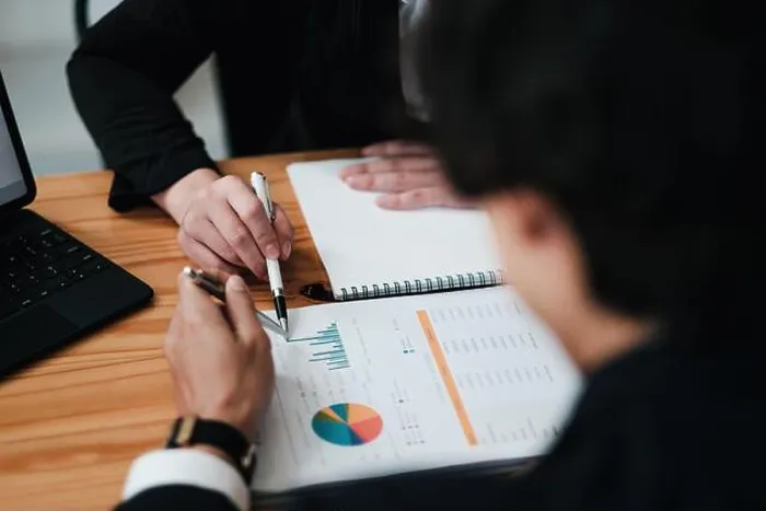 Framed Print : Diverse businesspeople discuss financial report in charts diagrams and graphs close up Framed Print : Diverse businesspeople discuss financial report in charts diagrams and graphs close up