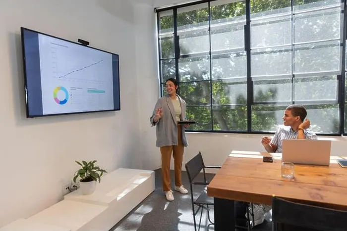 Framed Print : Diverse colleagues presenting data on screen in meeting room using tablet, laptop, copy space Framed Print : Diverse colleagues presenting data on screen in meeting room using tablet, laptop, copy space