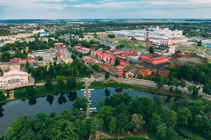 Framed Print : Dobrush, Gomel Region, Belarus. Aerial View Of Old Paper Factory Tower In Spring Day. Historical Heritage In Bird's-eye View Framed Print : Dobrush, Gomel Region, Belarus. Aerial View Of Old Paper Factory Tower In Spring Day. Historical Heritage In Bird's-eye View