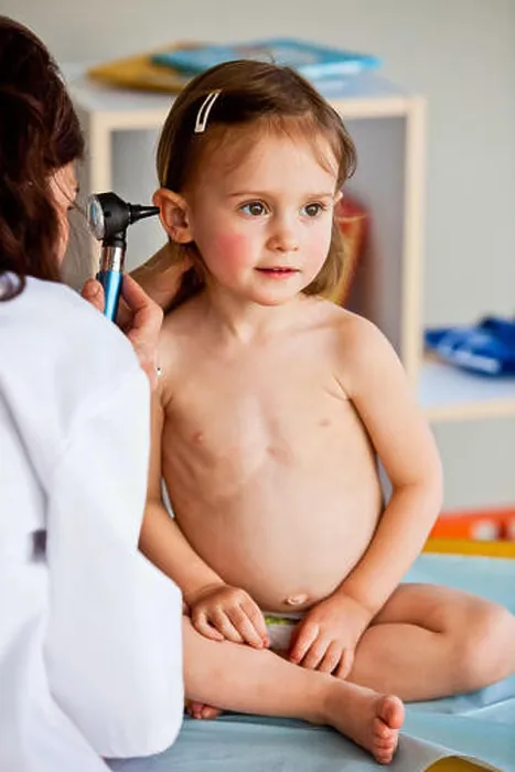 Framed Print : Doctor examining the ears of a 3-year-old girl with an otoscope Framed Print : Doctor examining the ears of a 3-year-old girl with an otoscope