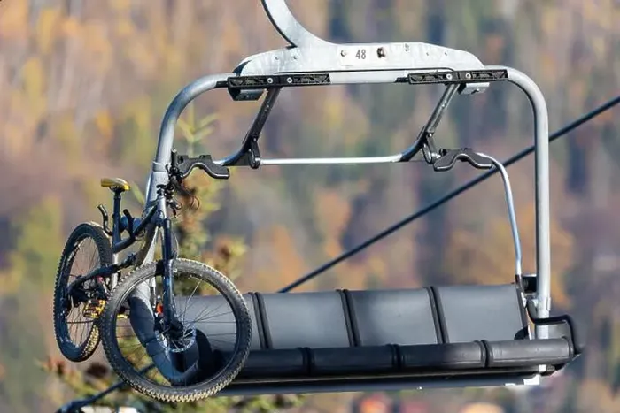 Framed Print : Downhill bicycle on a chairlift. Transportation of downhill bikes to the top of the mountain Framed Print : Downhill bicycle on a chairlift. Transportation of downhill bikes to the top of the mountain