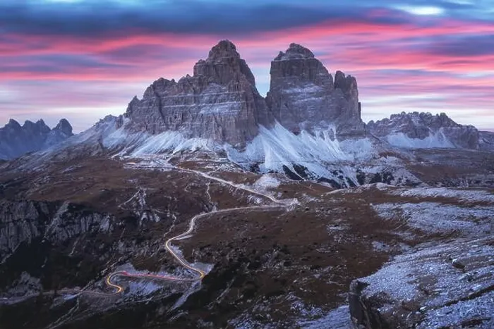 Framed Print : Dramatic evening landscape with Three peaks of Lavaredo mountains, glowing road and pink sunset sky Framed Print : Dramatic evening landscape with Three peaks of Lavaredo mountains, glowing road and pink sunset sky