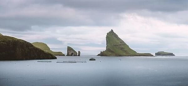Dramatic panoramical view on Drangarnir and Tindholmur sea stacks in Atlantic ocean, Faroe Islands. Landscape photography