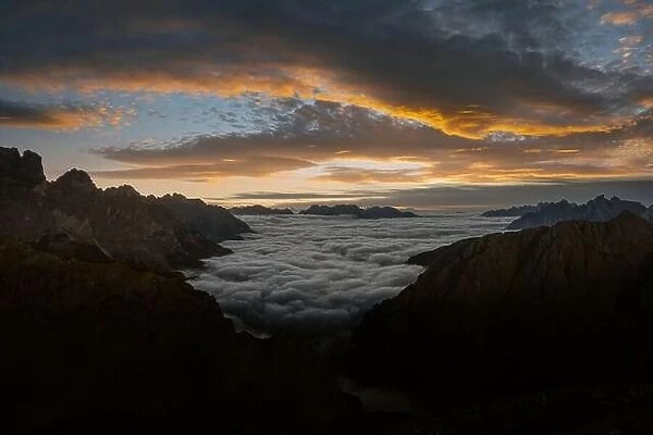 Dramatic sunrise landscape with flowing fog and pink skies in the Dolomites mountains. Location Auronzo rifugio in Tre Cime di Lavaredo National