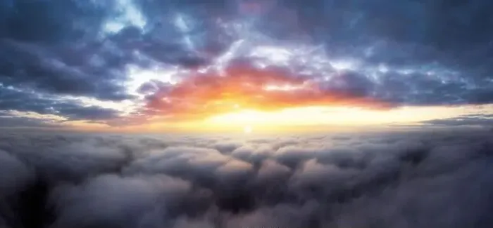 Framed Print : Dramatic sunrise sky above fluffy clouds early in the morning from aerial drone view