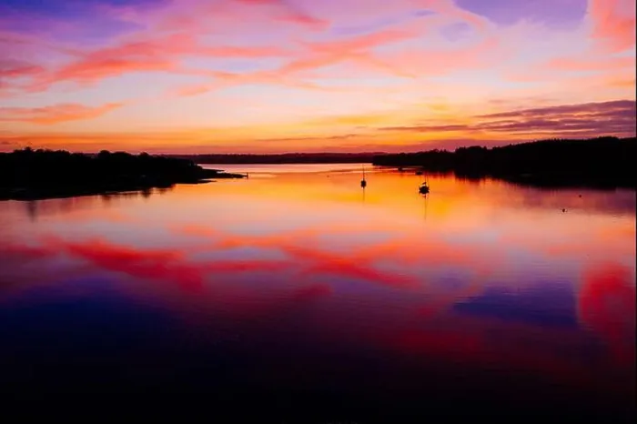 Framed Print : A dramatic sunset with a colorful cloudy sky and its reflection on a calm lake Framed Print : A dramatic sunset with a colorful cloudy sky and its reflection on a calm lake
