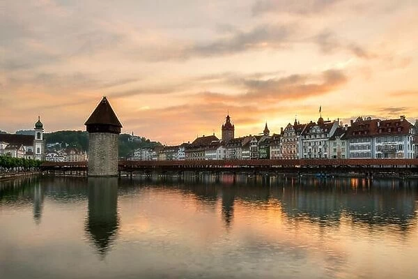 Dramatic sunset over the old town of Lucerne, Chapel Bridge and Water tower in Lucerne, Switzerland