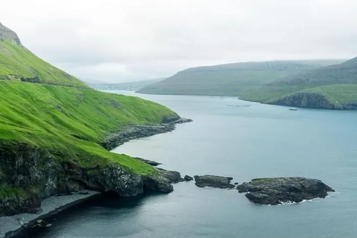 Framed Print : Dramatic view of green hills of Vagar island and Sorvagur town Framed Print : Dramatic view of green hills of Vagar island and Sorvagur town