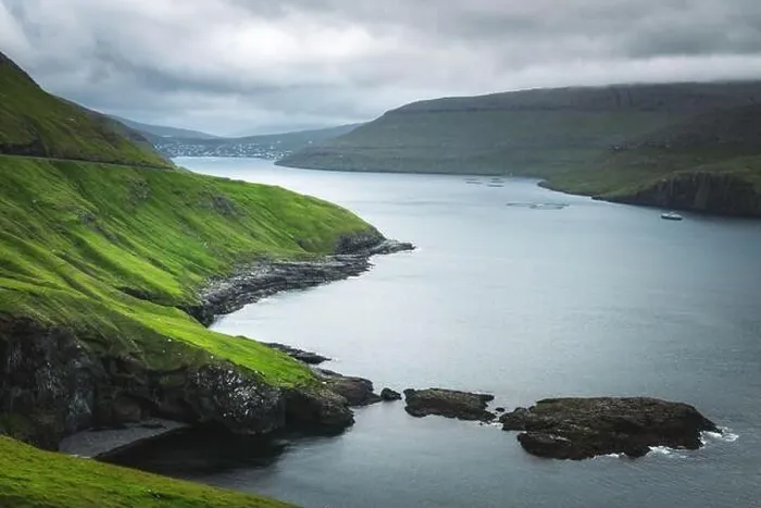 Framed Print : Dramatic view of green hills of Vagar island and Sorvagur town on background. Faroe islands, Denmark. Landscape photography Framed Print : Dramatic view of green hills of Vagar island and Sorvagur town on background. Faroe islands, Denmark. Landscape photography
