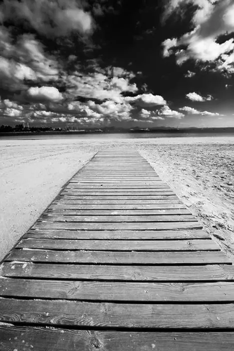 Framed Print : Dramatic view of a wooden boardwalk stretching along a beach towards the sea in Alcudia, Spain Framed Print : Dramatic view of a wooden boardwalk stretching along a beach towards the sea in Alcudia, Spain