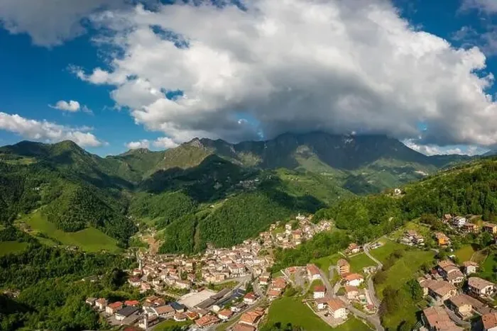 Framed Print : Drone aerial view to the Seriana valley and Orobie Alps with big cloud and blue sky Framed Print : Drone aerial view to the Seriana valley and Orobie Alps with big cloud and blue sky