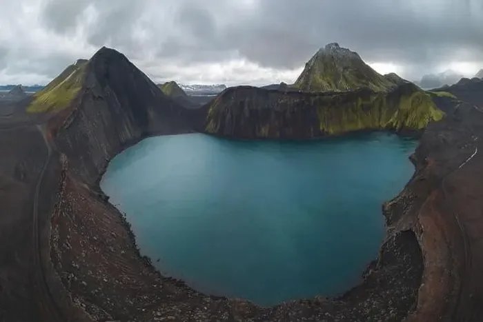 Framed Print : Drone capture of a striking turquoise lake nestled within multiple volcanic mounts in the Icelandic highlands Framed Print : Drone capture of a striking turquoise lake nestled within multiple volcanic mounts in the Icelandic highlands