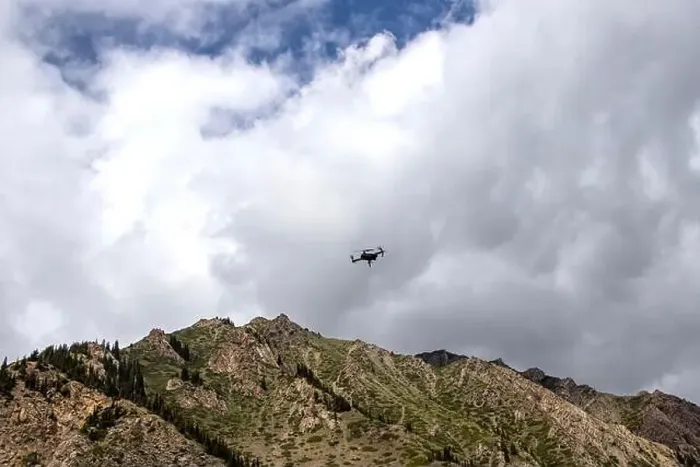 Framed Print : Drone in the cloudy sky over a mountain range. Traveling in Kyrgyzstan. Naryn Region Framed Print : Drone in the cloudy sky over a mountain range. Traveling in Kyrgyzstan. Naryn Region