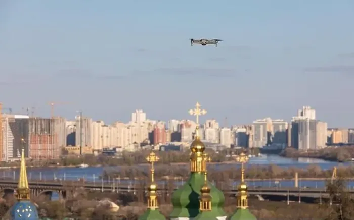 Framed Print : Drone flies over Vydubychi Monastery in Kyiv. Domes of the Christian monastery. Focus on drone with blurred background Framed Print : Drone flies over Vydubychi Monastery in Kyiv. Domes of the Christian monastery. Focus on drone with blurred background