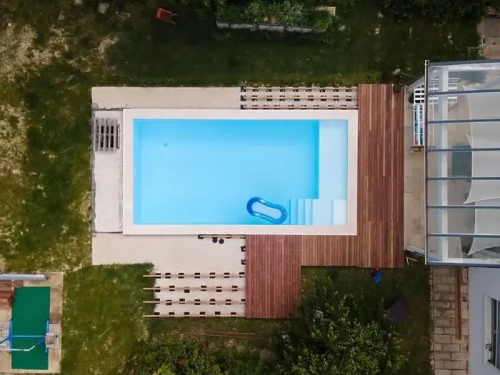 Framed Print : Drone flight over beautiful green garden with pool and the wooden terrace of the pool is currently in progress Framed Print : Drone flight over beautiful green garden with pool and the wooden terrace of the pool is currently in progress