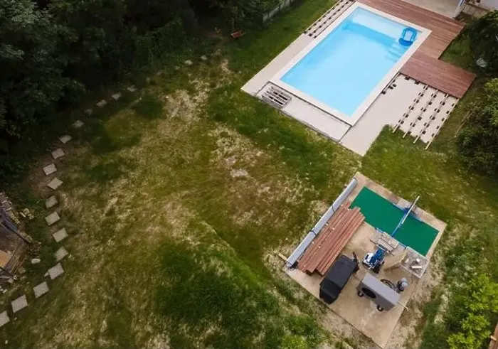 Framed Print : Drone flight over beautiful green garden with pool and the wooden terrace of the pool is currently in progress Framed Print : Drone flight over beautiful green garden with pool and the wooden terrace of the pool is currently in progress