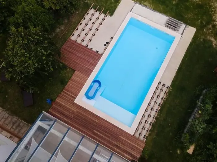 Framed Print : Drone flight over beautiful green garden with pool and the wooden terrace of the pool is currently in progress Framed Print : Drone flight over beautiful green garden with pool and the wooden terrace of the pool is currently in progress
