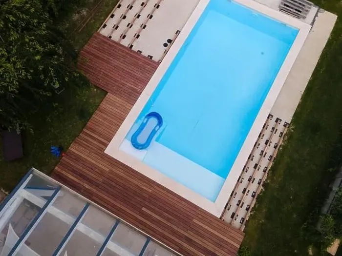 Framed Print : Drone flight over beautiful green garden with pool and the wooden terrace of the pool is currently in progress Framed Print : Drone flight over beautiful green garden with pool and the wooden terrace of the pool is currently in progress
