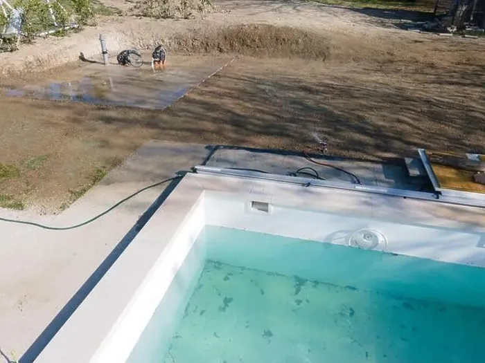 Framed Print : Drone flight over fresh earth area with grass grown next to pool construction site in April Framed Print : Drone flight over fresh earth area with grass grown next to pool construction site in April
