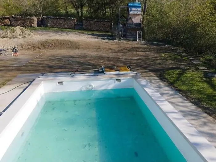 Framed Print : Drone flight over fresh earth area with grass grown next to pool construction site in April Framed Print : Drone flight over fresh earth area with grass grown next to pool construction site in April